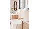 Bright bathroom features a modern standalone tub, stylish fixtures, and wooden cabinets at 535 Albion St, Denver, CO 80220