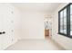 Bright, carpeted bedroom features a modern black-trimmed window and white door with black hardware at 535 Albion St, Denver, CO 80220