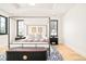 Modern bedroom boasts a four poster bed, patterned rug, stylish decor, and tray ceiling at 535 Albion St, Denver, CO 80220