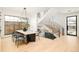 Dining room with statement chandelier, staircase, and view of back yard at 535 Albion St, Denver, CO 80220