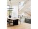 Dining room with decorative staircase, light hardwood floors, and designer chandelier at 535 Albion St, Denver, CO 80220