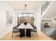 Bright dining room with modern chandelier, staircase and large windows at 535 Albion St, Denver, CO 80220