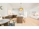 Open concept kitchen features island with bar seating and eat-in dining area at 535 Albion St, Denver, CO 80220