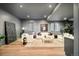 Modern living room with recessed lighting and neutral decor, plus light wood floors and two windows at 535 Albion St, Denver, CO 80220