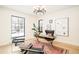 Sunlit home office with modern furniture, area rug, and black-trimmed windows at 535 Albion St, Denver, CO 80220