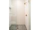 Modern shower with elegant fixtures, herringbone tile floor, and glass door at 535 Albion St, Denver, CO 80220
