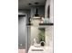 A well-lit wet bar is decorated with modern pendant lighting, glassware, and a unique art piece at 535 Albion St, Denver, CO 80220
