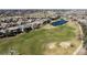 An aerial view of a vibrant neighborhood with a golf course and serene ponds at 9099 E Harvard Ave, Denver, CO 80231