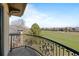 An elegant wrought iron balcony overlooking a green and charming neighborhood at 9099 E Harvard Ave, Denver, CO 80231