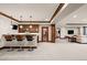 Finished basement features a bar with seating, wooden trim, and carpeted floors at 9099 E Harvard Ave, Denver, CO 80231