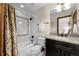 A bright bathroom featuring a shower/tub combination and dark vanity with granite countertops at 9099 E Harvard Ave, Denver, CO 80231