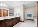 An expansive bathroom with a double sink vanity and walk-in shower at 9099 E Harvard Ave, Denver, CO 80231