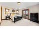 This bedroom features a black frame bed, carpeted floors, and a private balcony at 9099 E Harvard Ave, Denver, CO 80231