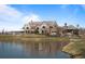 A gorgeous property featuring a serene lake, elegant clubhouse, and lush landscaping at 9099 E Harvard Ave, Denver, CO 80231