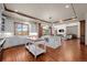 Large open concept kitchen featuring stainless steel appliances, center island, breakfast bar, and open to the living room at 9099 E Harvard Ave, Denver, CO 80231