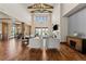 Spacious living room with soaring ceilings, a fireplace, hardwood floors, and elegant furniture at 9099 E Harvard Ave, Denver, CO 80231