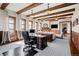 Spacious Living Room with wooden beams, home office, tv, fireplace, and piano at 9099 E Harvard Ave, Denver, CO 80231