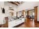 Bright and airy living room showcasing hardwood floors, vaulted ceilings, and an open floor plan to the kitchen and dining room at 9099 E Harvard Ave, Denver, CO 80231