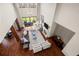 Expansive living room boasts high ceilings, wood floors, fireplace, and access to outdoor balcony for entertaining at 9099 E Harvard Ave, Denver, CO 80231