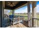 Cozy covered patio featuring ample seating, an outdoor grill, and views of the golf course at 9099 E Harvard Ave, Denver, CO 80231