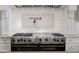 Close up of a high-end stainless steel range with pot filler and custom tile backsplash at 9099 E Harvard Ave, Denver, CO 80231
