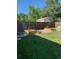 Backyard featuring raised garden beds, lush green grass, and a wooden fence for added privacy at 6614 Everett St, Arvada, CO 80004