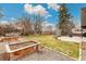 Large backyard featuring garden boxes, a concrete patio, a storage shed and a well-maintained lawn at 6614 Everett St, Arvada, CO 80004