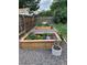 Landscaped backyard featuring raised garden beds with a variety of colorful flowers and plants at 6614 Everett St, Arvada, CO 80004