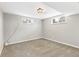 Spacious basement featuring neutral carpeting, a window for natural light, and a cozy atmosphere at 6614 Everett St, Arvada, CO 80004