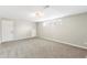 Bright basement with neutral carpeting, a utility closet, and a window providing plenty of natural light at 6614 Everett St, Arvada, CO 80004