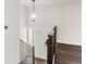 View of the entryway with a white front door, stairwell, and dark wood-look flooring at 6614 Everett St, Arvada, CO 80004