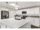 Bright kitchen featuring granite counters, stainless steel appliances and skylight at 6614 Everett St, Arvada, CO 80004