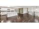Large open space with a view of kitchen, Gathering room, and stairwell at 6614 Everett St, Arvada, CO 80004