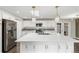 Spacious kitchen with a large island, modern appliances, and plenty of cabinet space at 6614 Everett St, Arvada, CO 80004