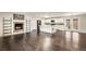 Open-concept kitchen featuring white cabinets, an island, and hardwood floors at 6614 Everett St, Arvada, CO 80004