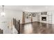 Bright living room with wood floors, a window, a fireplace, and open railing to the stairwell at 6614 Everett St, Arvada, CO 80004