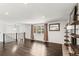 Spacious living room with dark hardwood floors, a fireplace, and natural light from the large window at 6614 Everett St, Arvada, CO 80004