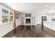 Bright living room featuring hardwood floors, a fireplace, and large windows at 6614 Everett St, Arvada, CO 80004