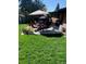 Grassy backyard featuring an outdoor dining set on a concrete patio for enjoyable outdoor meals at 6614 Everett St, Arvada, CO 80004