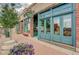 Attractive storefront with plants, a wooden barrel, brick accents, and a vibrant sign inviting shoppers to explore unique products at 6614 Everett St, Arvada, CO 80004