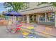 Colorful storefront with outdoor seating, a striped awning, and eye-catching displays, creating a welcoming shopping environment at 6614 Everett St, Arvada, CO 80004