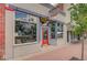 Welcoming storefront with a vibrant red door, and visible signage to attract customers and create a memorable shopping experience at 6614 Everett St, Arvada, CO 80004