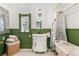 Charming bathroom featuring a clawfoot tub, beaded wainscoting, and vintage-style fixtures at 3015 Lowell Blvd, Denver, CO 80211
