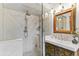 Stylish bathroom with glass enclosed shower, ornate mirror, and unique floral vanity at 3015 Lowell Blvd, Denver, CO 80211