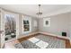 Bedroom with hardwood floors, a patterned rug, and access to an outdoor balcony at 3015 Lowell Blvd, Denver, CO 80211