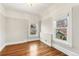Bright bedroom with hardwood floors, two large windows, and decorative white trim at 3015 Lowell Blvd, Denver, CO 80211