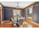 Formal dining room with dark walls, decorative wood trim, and a view into an adjoining living room at 3015 Lowell Blvd, Denver, CO 80211