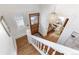 Bright foyer featuring an elegant chandelier, decorative staircase, and stained glass window at 3015 Lowell Blvd, Denver, CO 80211