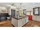 Kitchen features a large island with seating, custom cabinets and stainless steel appliances at 3015 Lowell Blvd, Denver, CO 80211