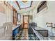 Bright laundry room with skylight, checkerboard floors, and modern washer and dryer at 3015 Lowell Blvd, Denver, CO 80211